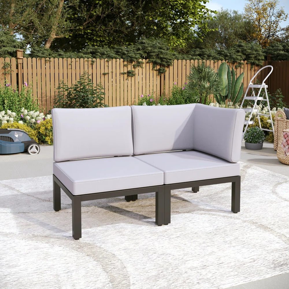 Corner garden sofa arranged in a compact patio corner