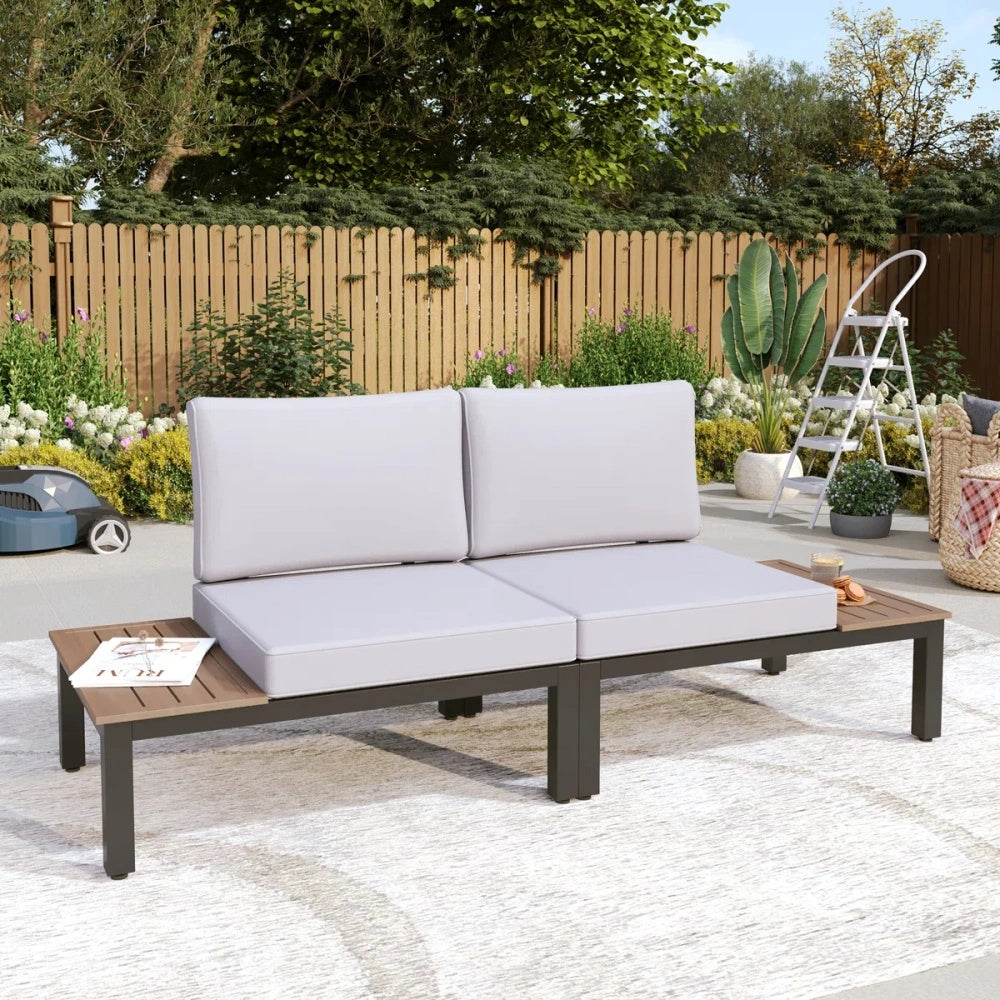 2-seater garden sofa with built-in wooden side tables set in a classic backyard setting