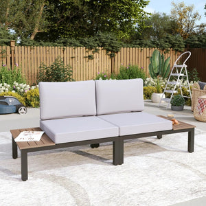2-seater garden sofa with built-in wooden side tables set in a classic backyard setting