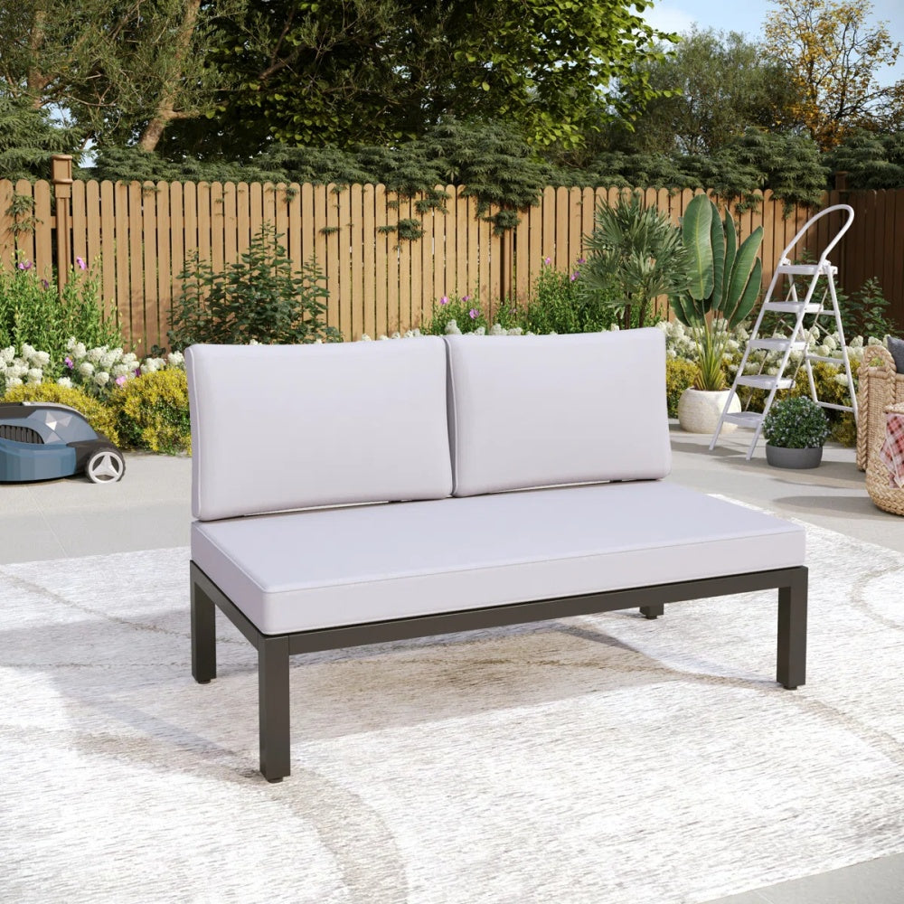 2-seater garden sofa with thick cushions in a classic backyard setting