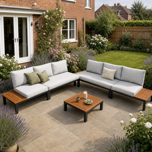 Outdoor patio with sectional sofa, coffee table, and garden setting